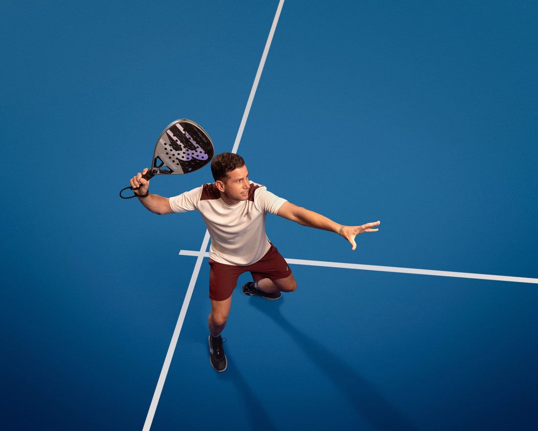 Professional padel player Paquito Navarro holding his Bullpadel Hack racket on court.