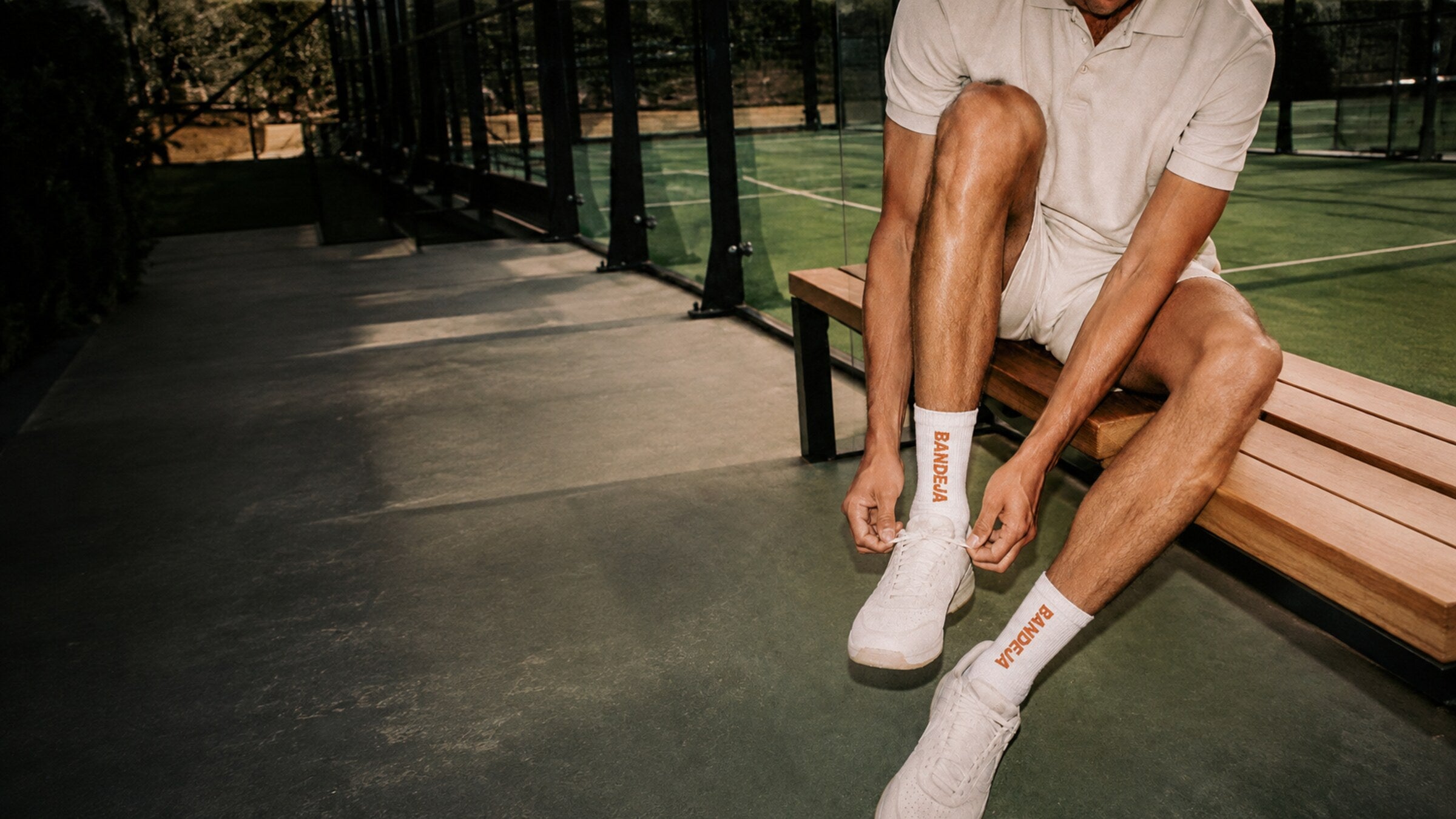 Padel player preparing beside an outdoor court